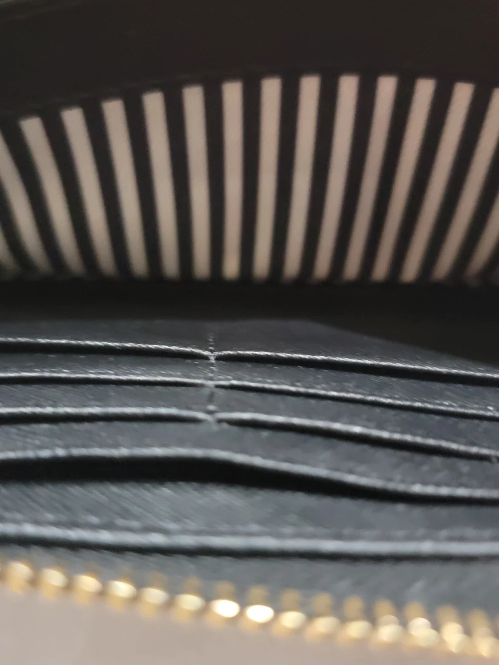 kate spade black zip-around Saffiano leather wallet with gold logo